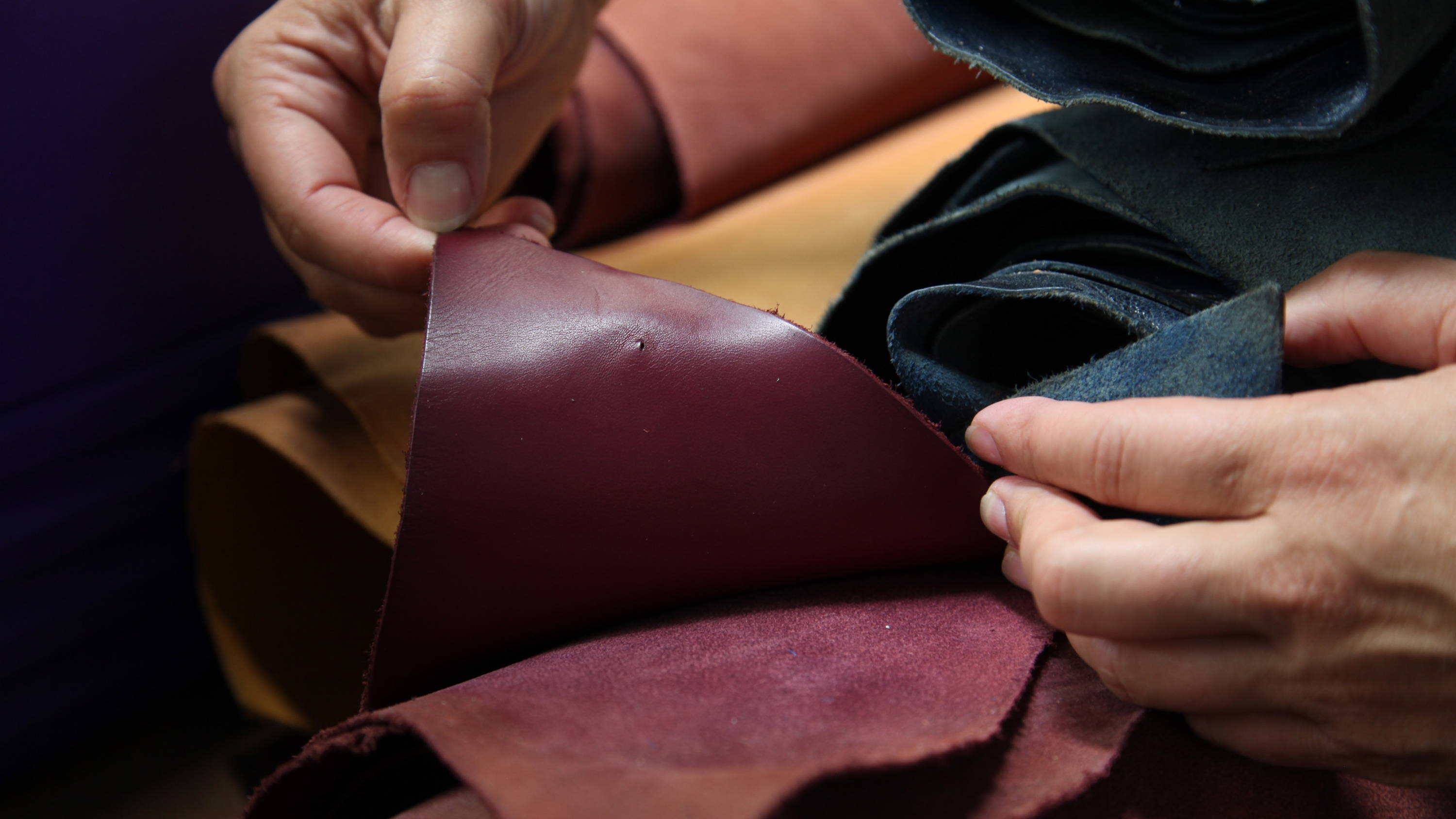 leather artisan Danny hand-finishing vegetable-tanned leather at Stick and Ball studio