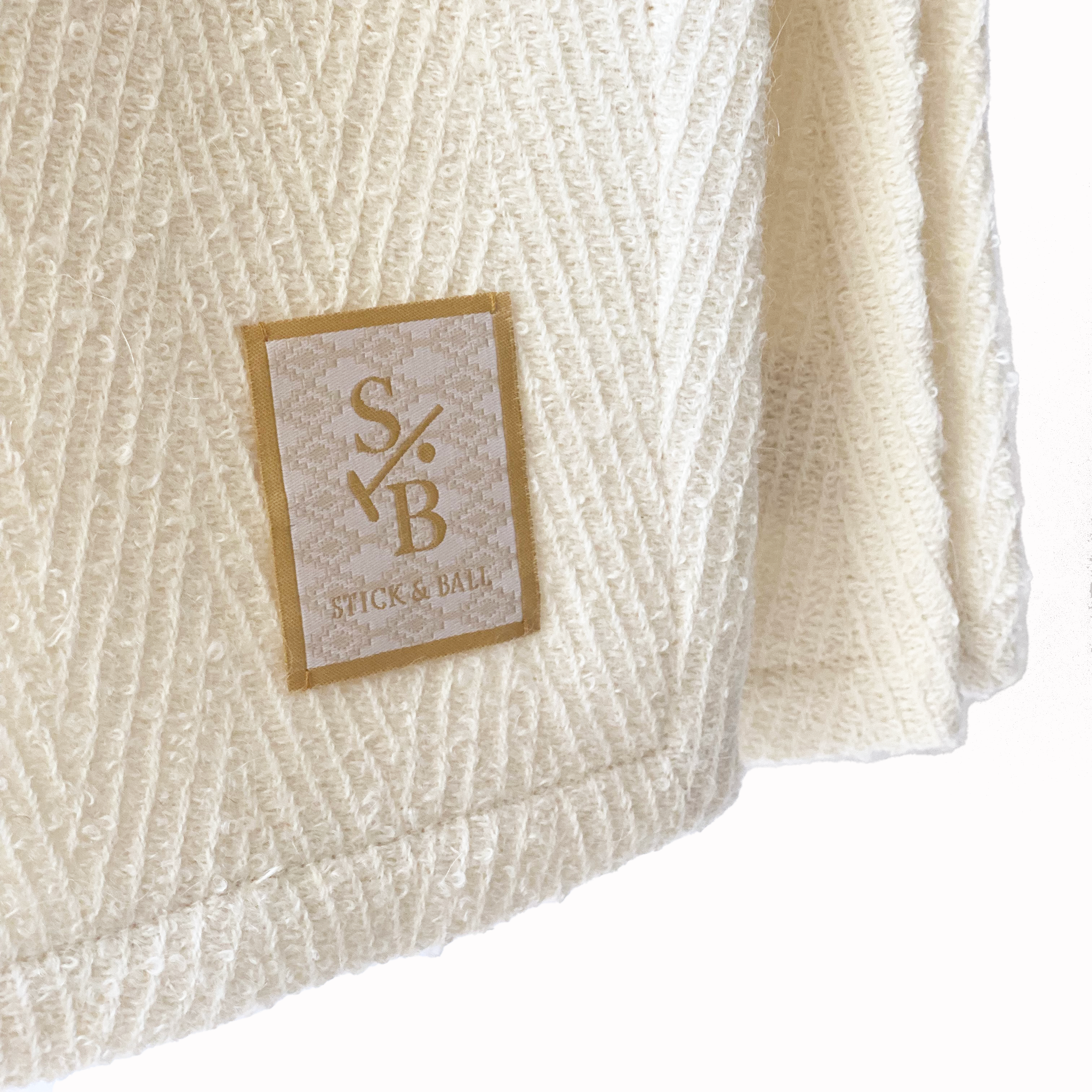 stick-and-ball-label-on-alpaca-chevron-throw-in-creamy-white
