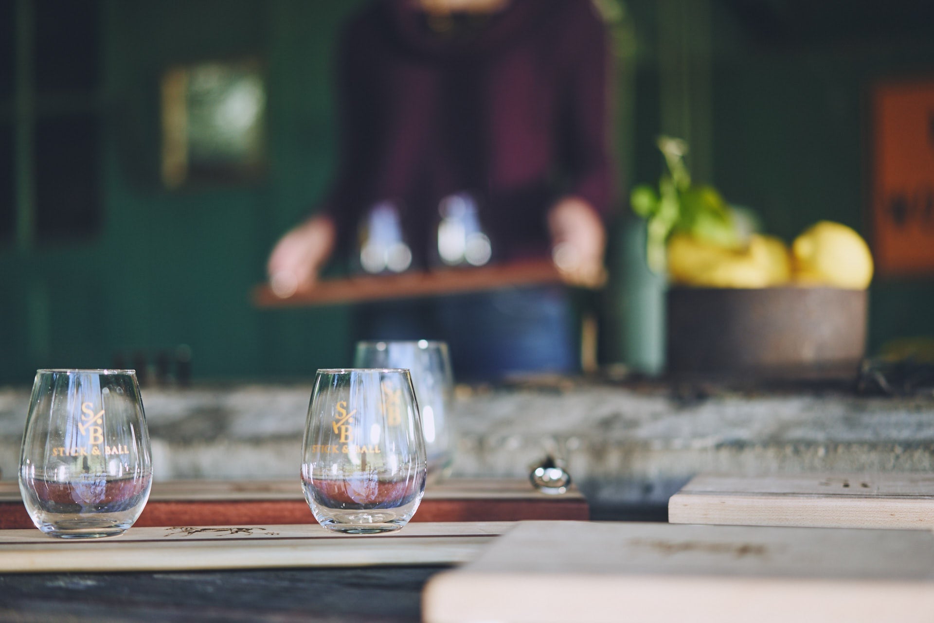 Collection image for Entertaining - Model setting a table with Stick and Ball stemless wine glasses