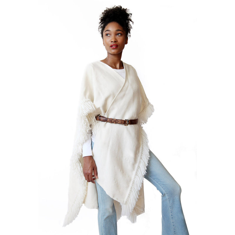 woman-wearing-stick-and-ball-apparel-womens-fringed-alpaca-ruana-wrap-winter-white-with-designer-belt