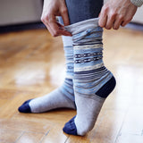 Woman putting on Pampa Boot Sock in Blue & Grey - Stick & Ball 