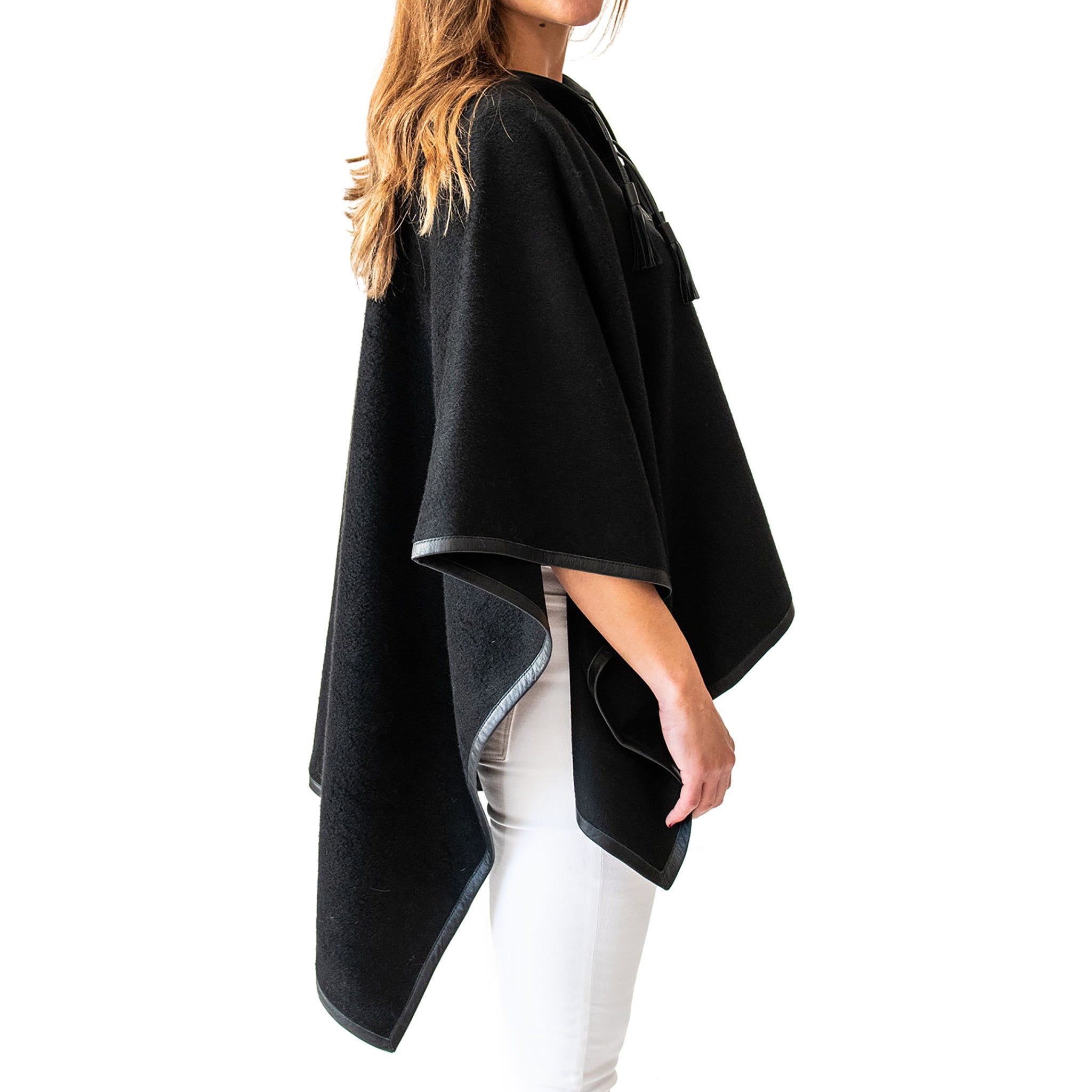 Woman wearing Italian Leather Trim Tassel Alpaca Poncho - Black, side view - Stick & Ball  